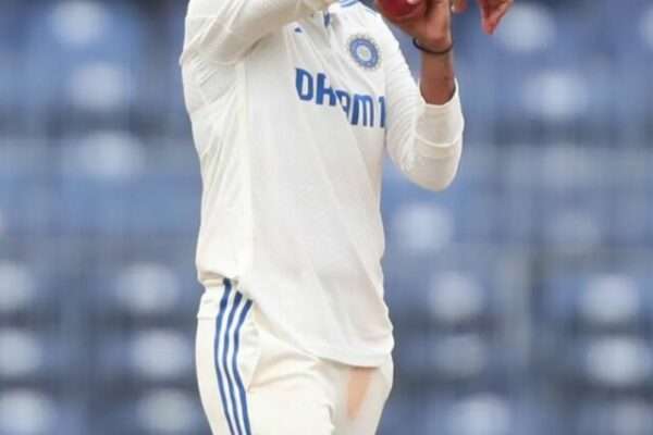 Indian Captain Harmanpreet Kaur bowling off-spin in Test match whites.